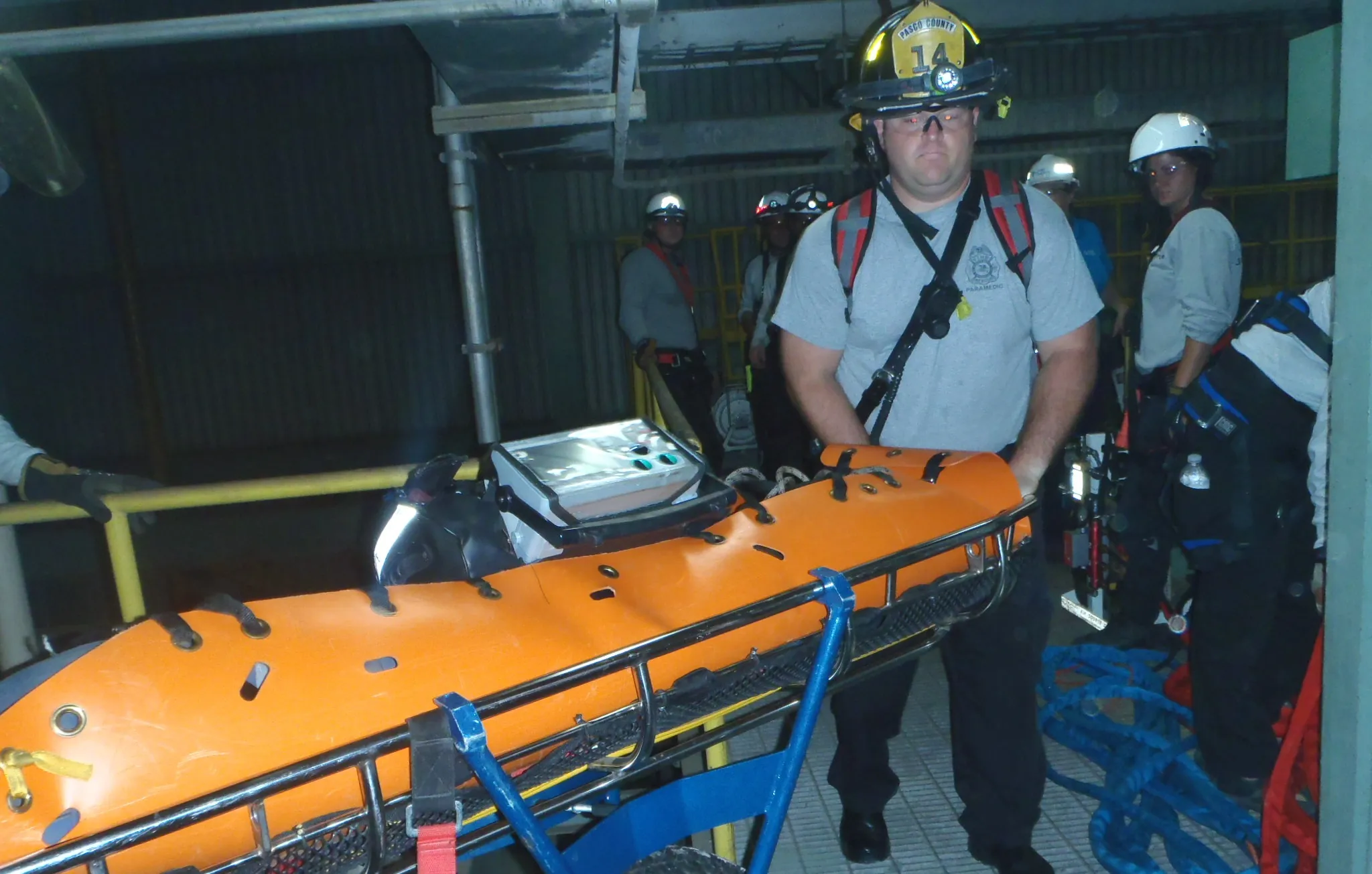 Rescuer staging a stretcher for a confined space rescue