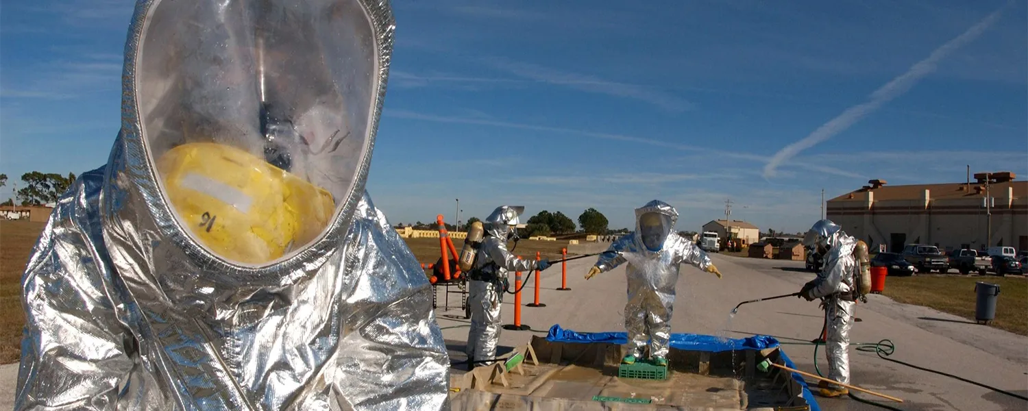 A responder in an aluminized proximity suit during a hazmat drill